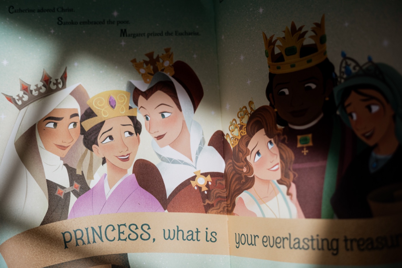 Interior spread from Princesses of Heaven: The Jewels showing six saints, each wearing a crown